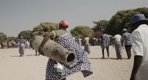 Kwamashi Cultural Drumer carrying a traditional drum