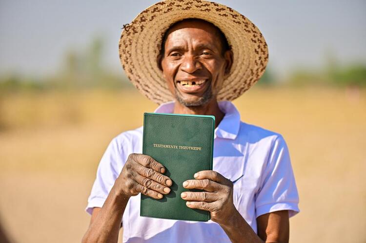 Exictedly holding the Kwamashi New Testament Bible for the time 