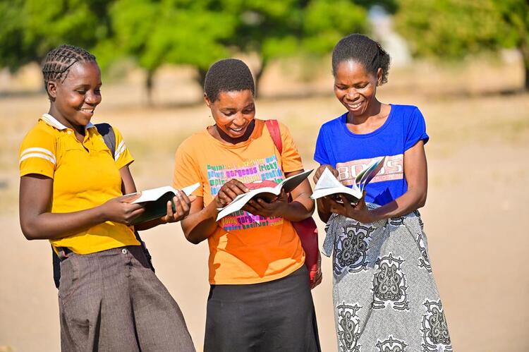 Ladies exictedly reading the bible in Kwamashi language for the first time 